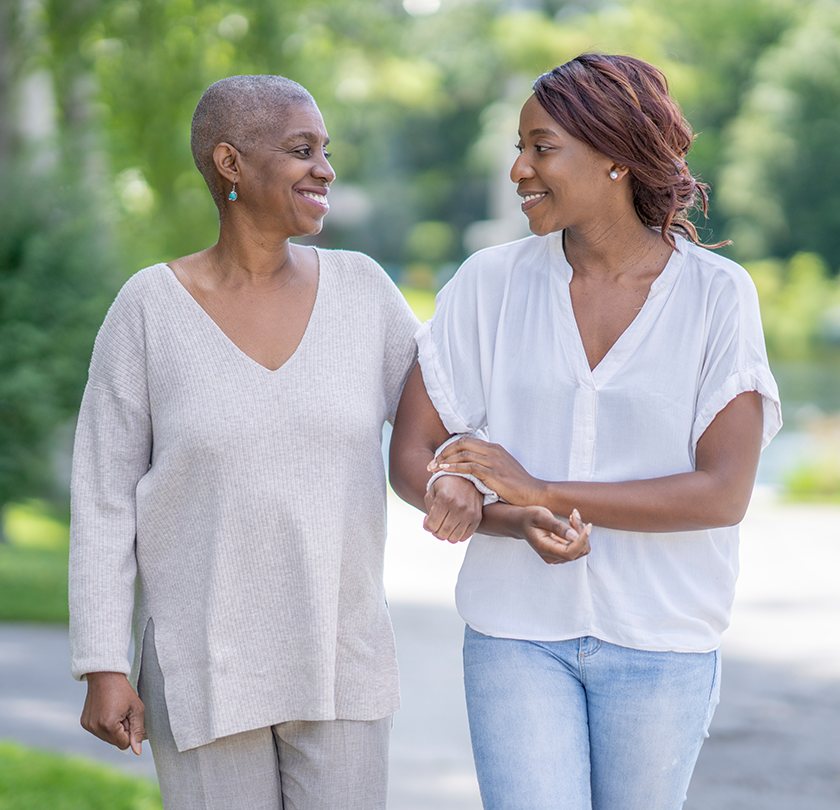 Adult woman walking with elderly mother