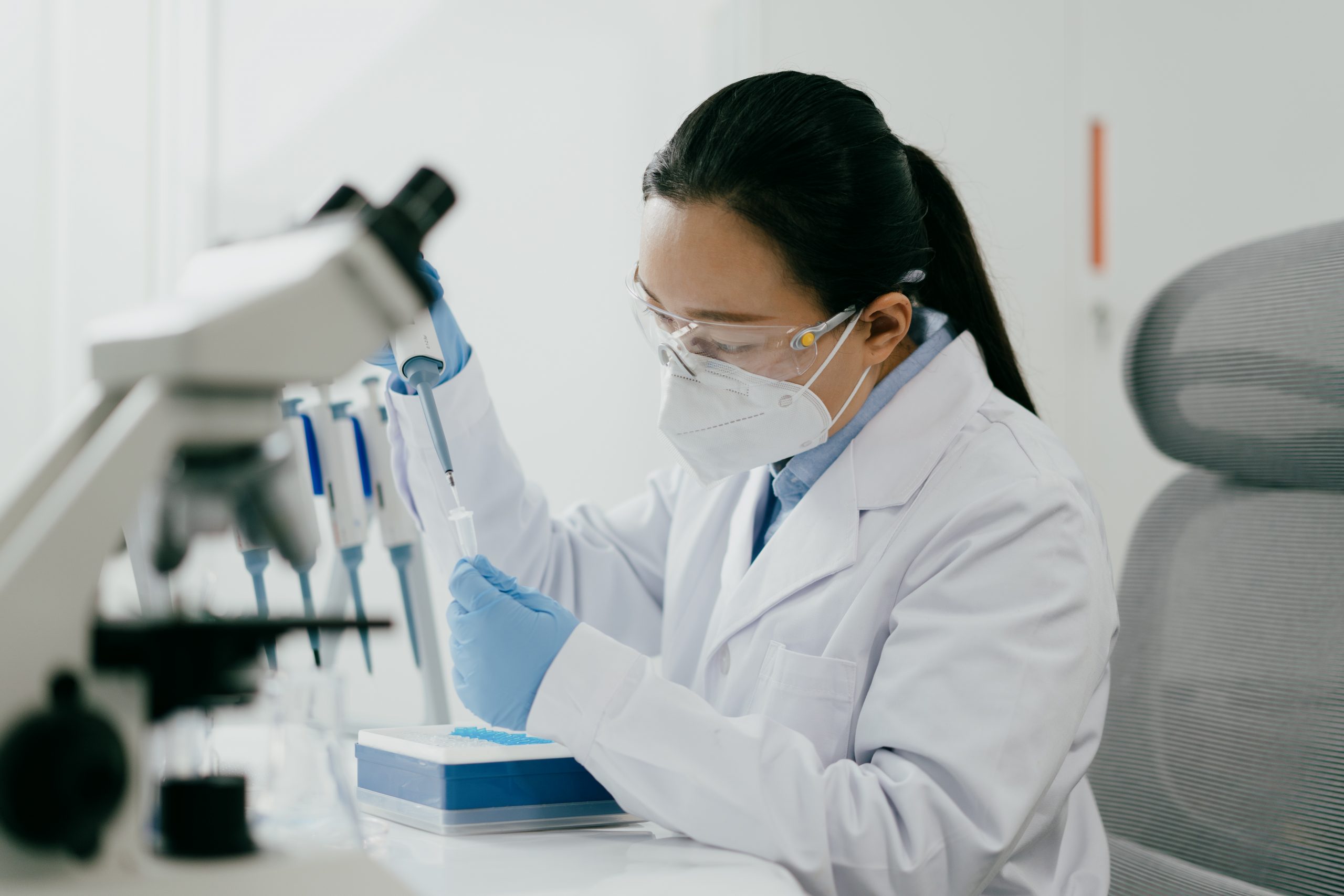 Scientist adding reagents to centrifuge tubes in laboratory