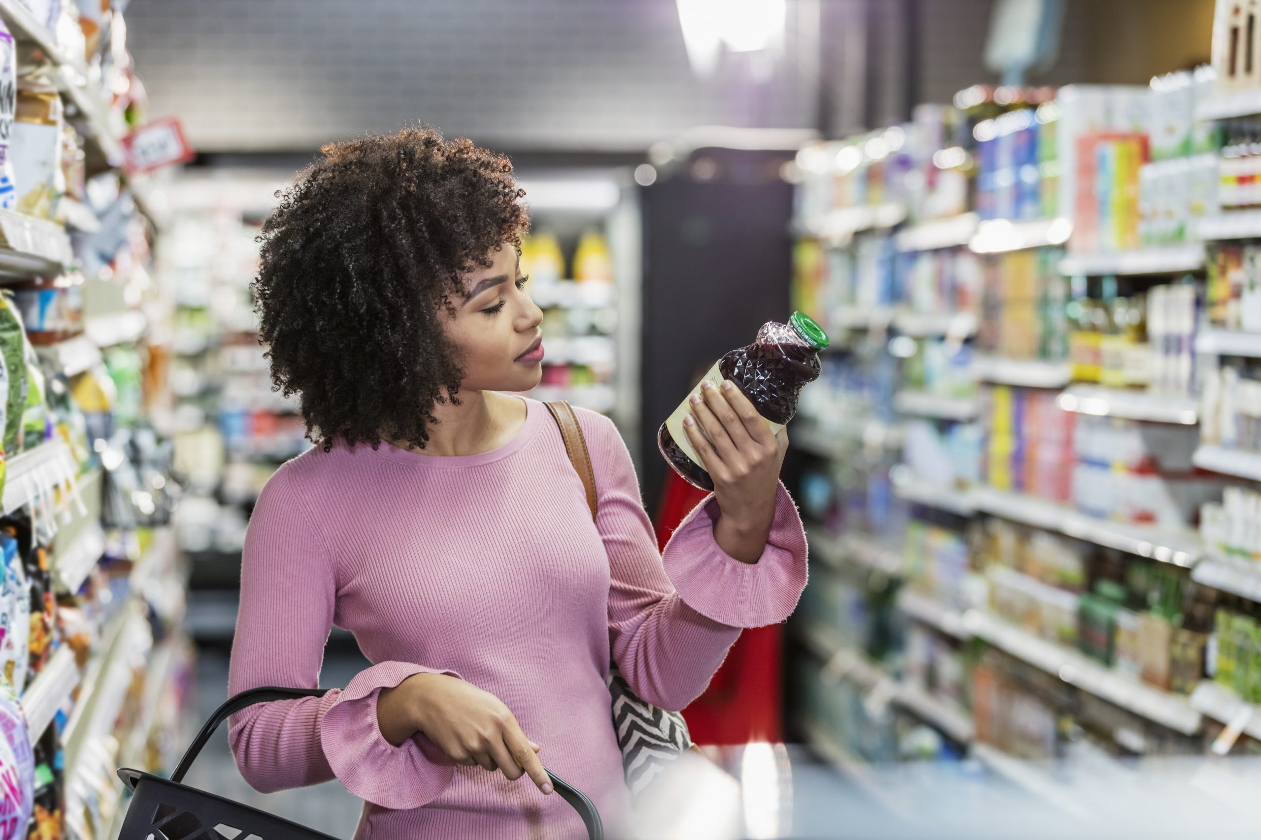 Young African-American woman shopping in supermarket Young African-American woman shopping in supermarket