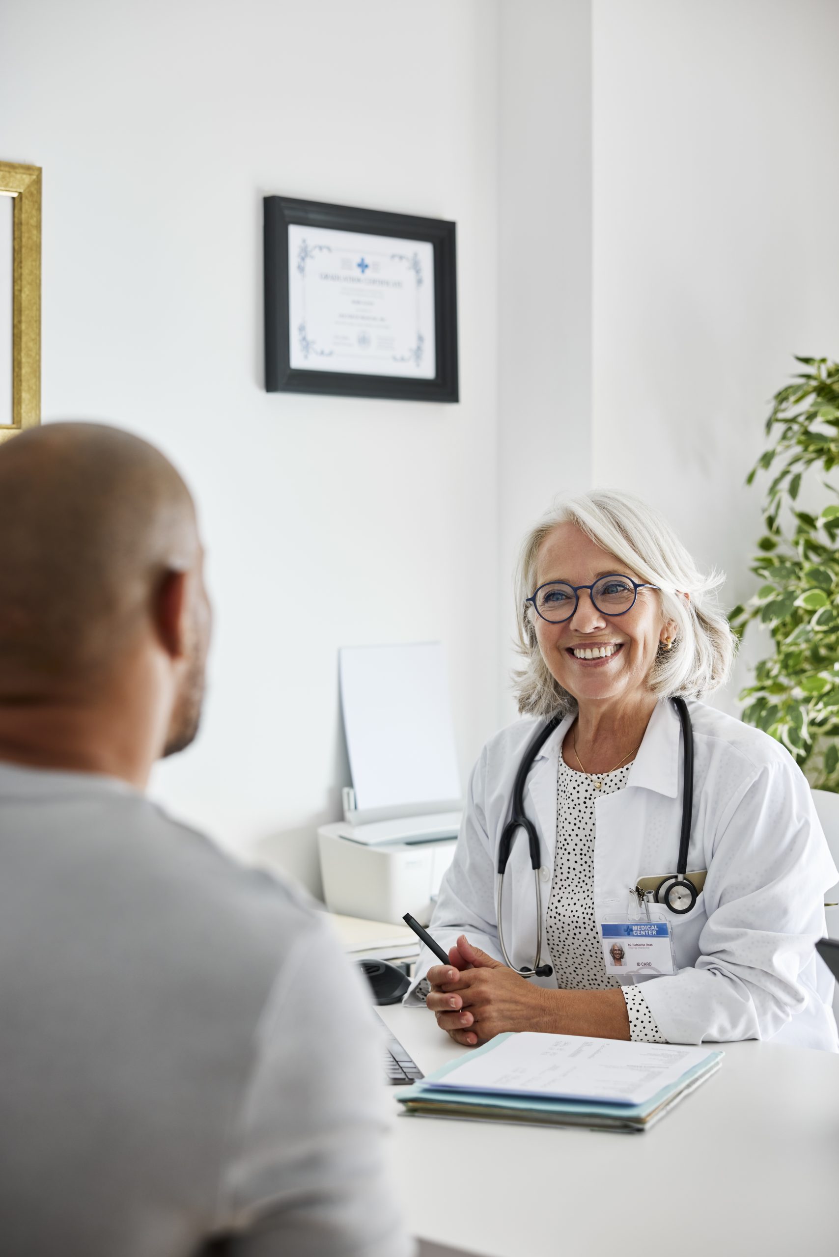 Senior doctor consulting patient at clinic