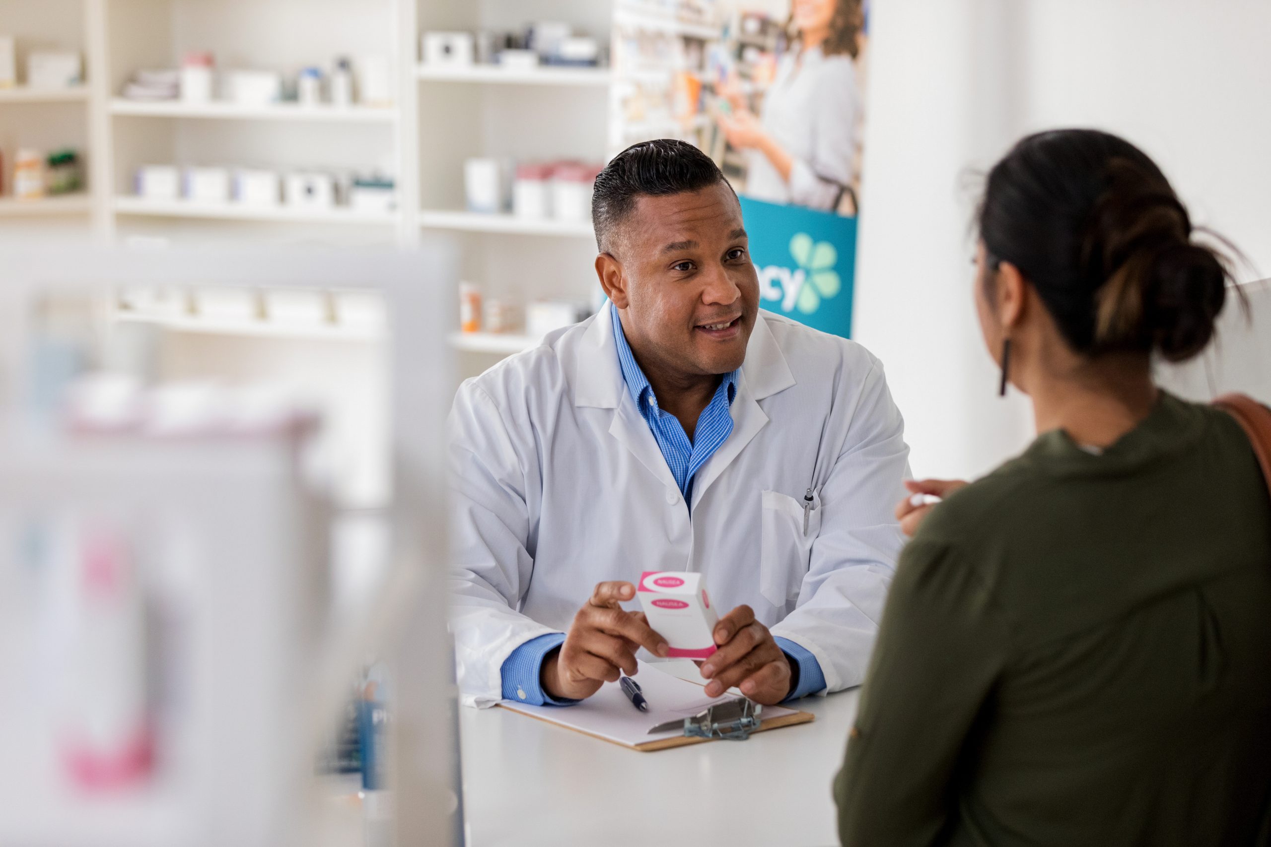Pharmacist explains side effects of generic drug to unrecognizable customer