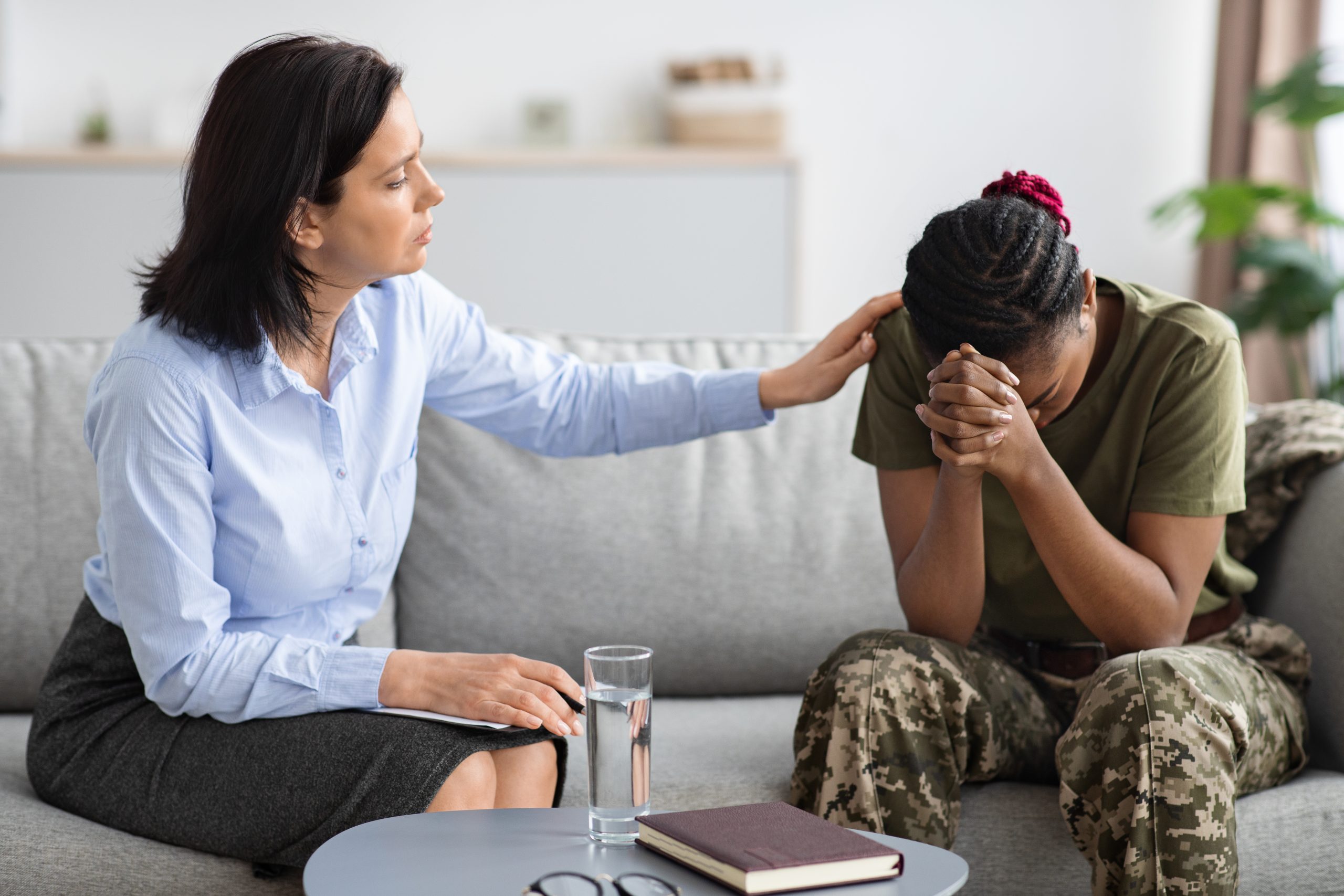 Complex PTSD. Psychologist Lady Comforting African American Military Woman At Therapy Session Psychologist Lady Comforting African American Military Woman At Therapy Session