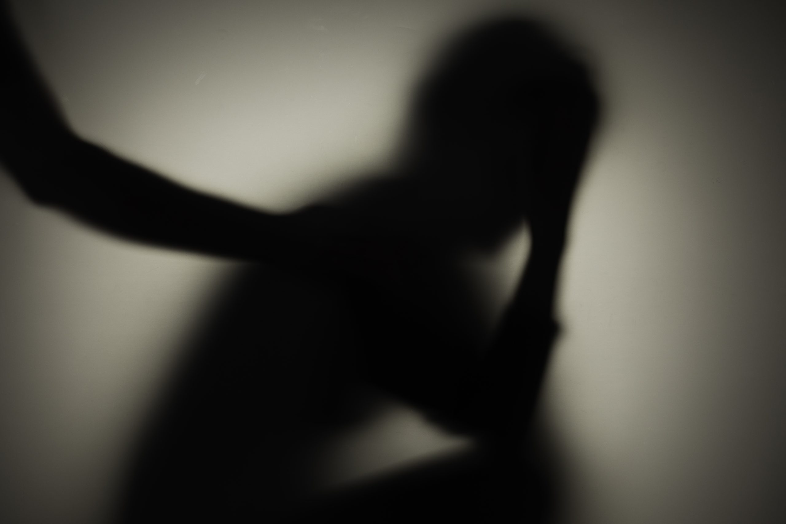 Unrecognizable sad woman and man in silhouette