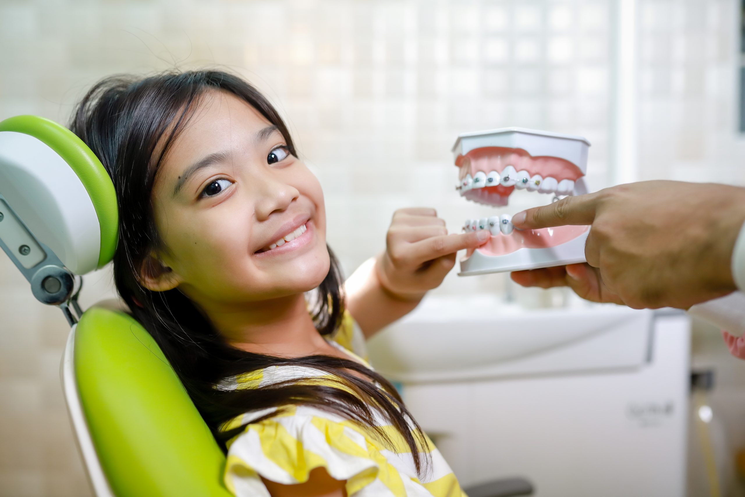 This cute girl is getting ready for her regular dental appointment at the dentist's office checkup.pediatric medical care concept.