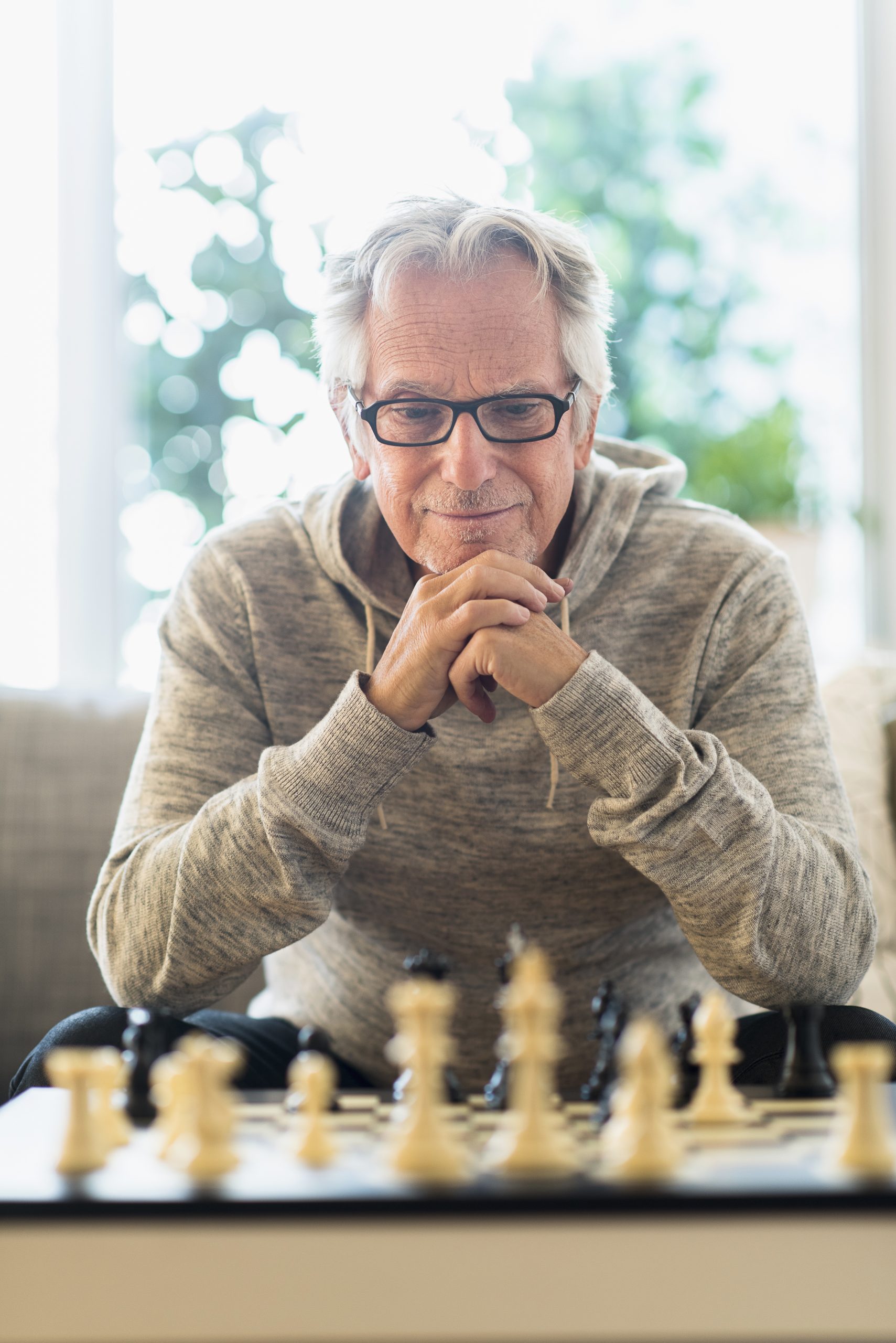 USA, New Jersey, Senior man playing chess