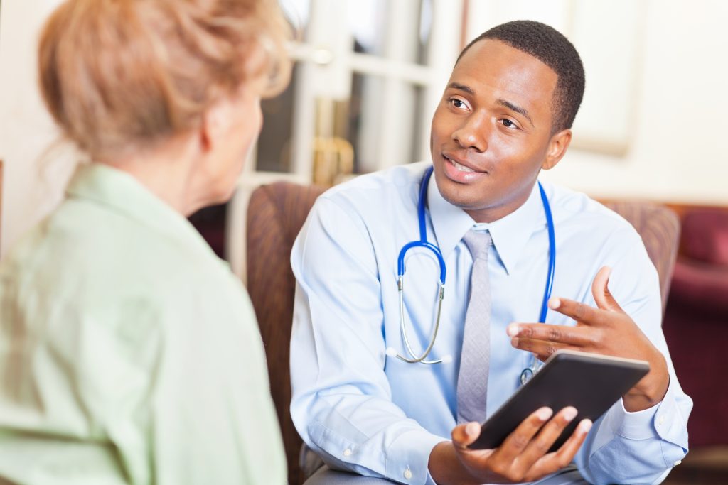 Young doctor speaking to patient or colleague