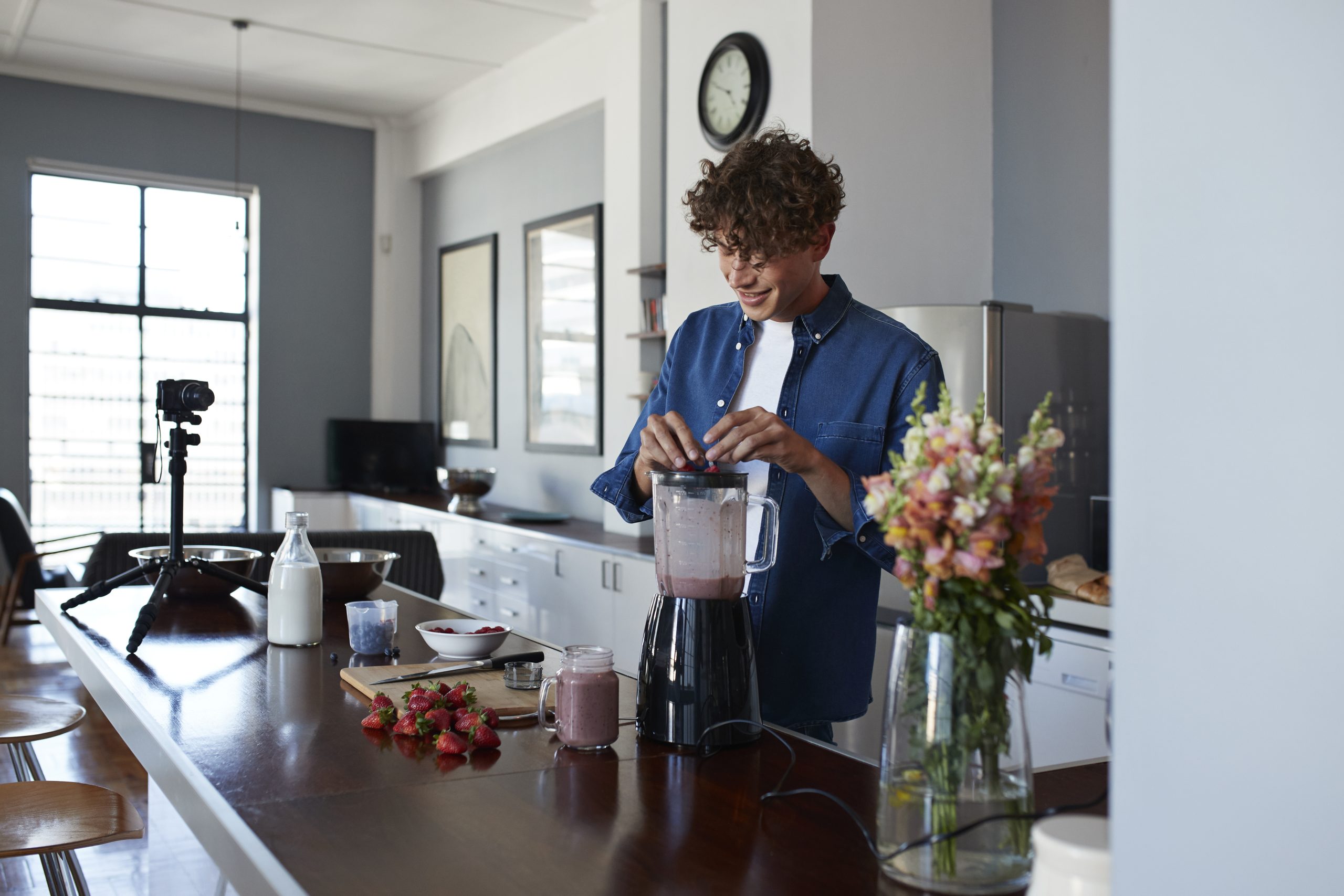 Male food vlogger making video of blending a smoothie Male food vlogger making video of blending a smoothie