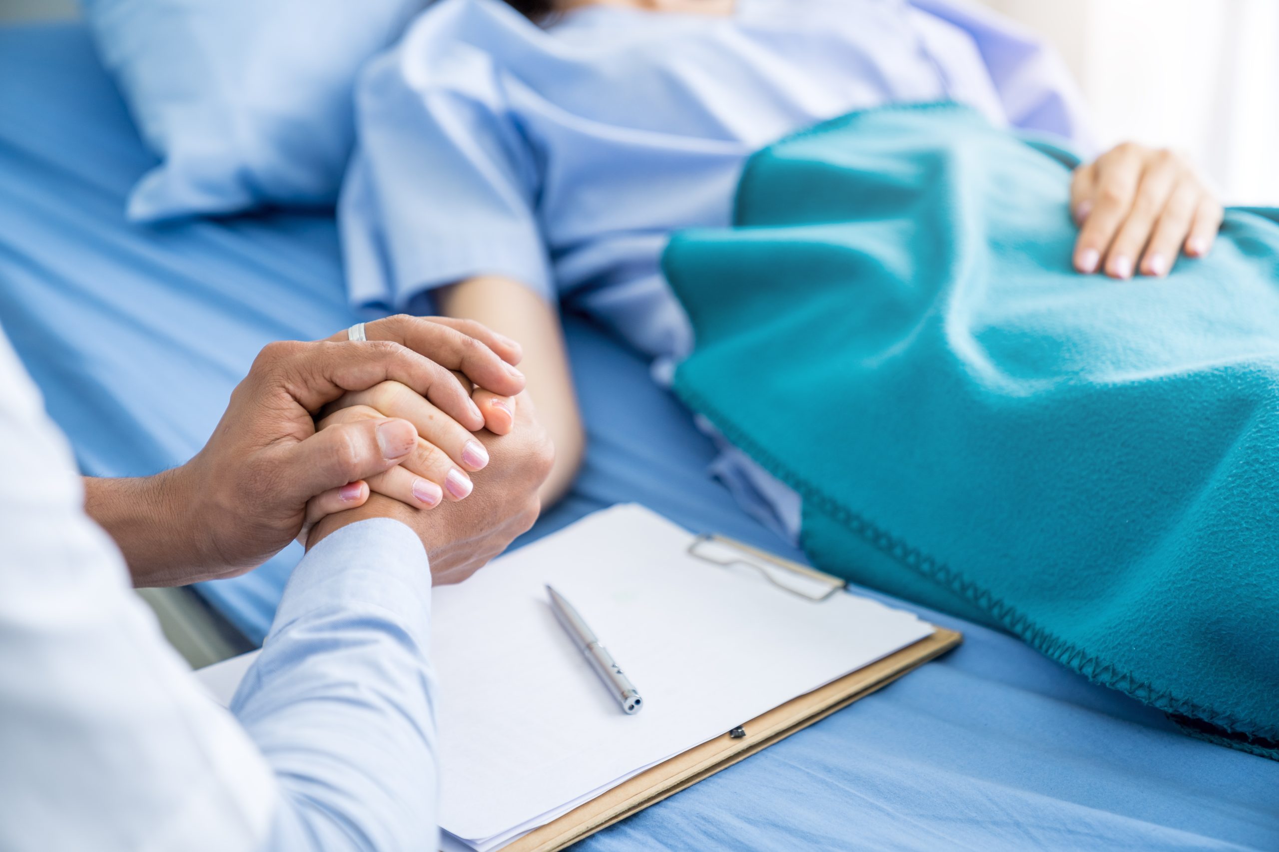 Close-up hands of expert doctors taking care of patient