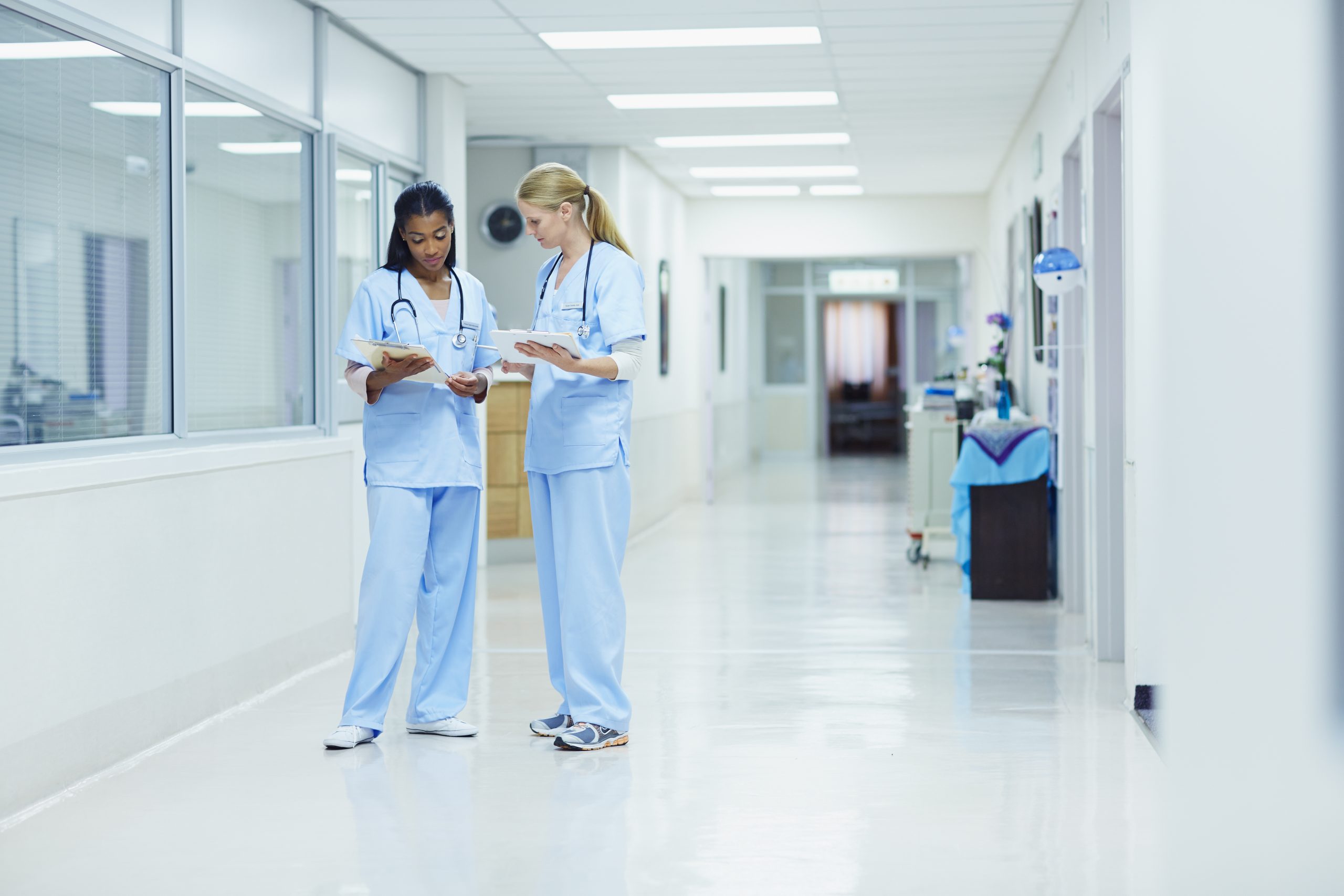 Nurses discussing medical documents in hospital
